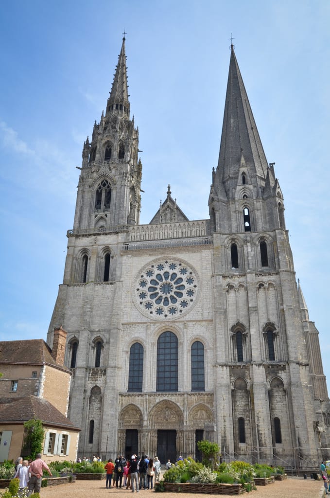 Chartres Cathedral, a tall gothic cathedral with two mismatching towers in front of it.