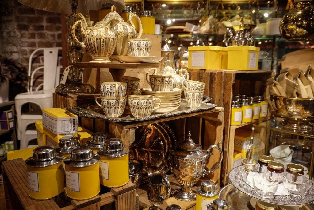 Rows of yellow cups, housewares, and accessories at the Paris Market.