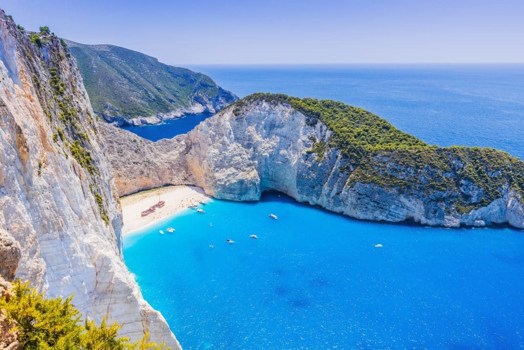Aerial view of Navagio Beach with clear blue water and the shipwreck on the white sand